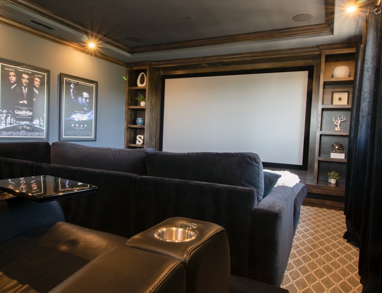 Home theater addition with dark wood moulding and coffered ceiling