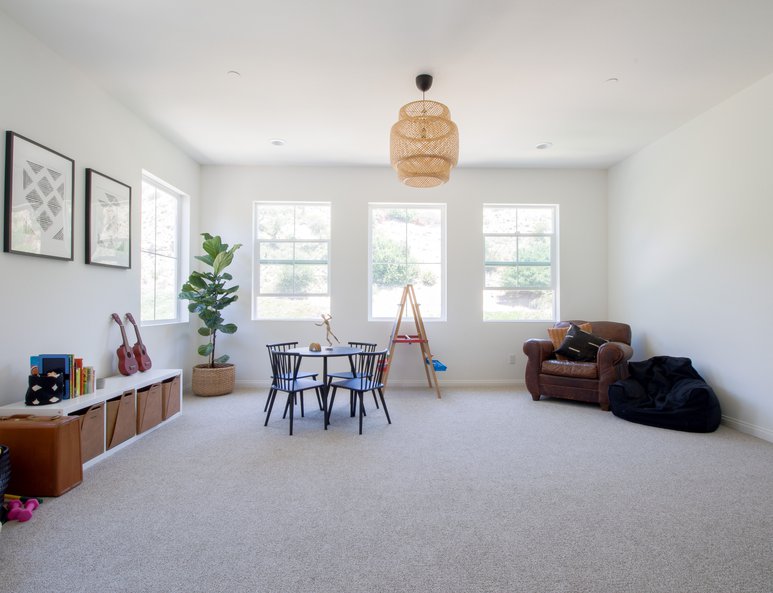 Large playroom with ample lighting and seating area