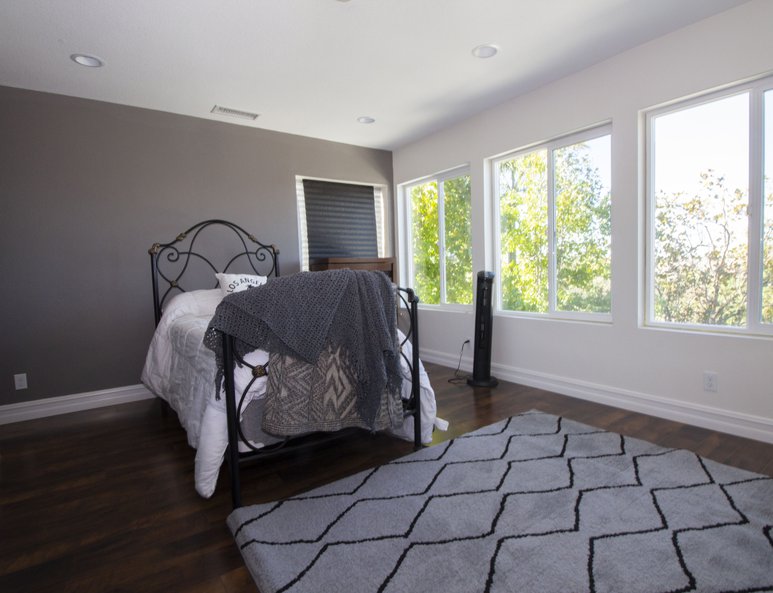 Guest bedroom with ample lighting.