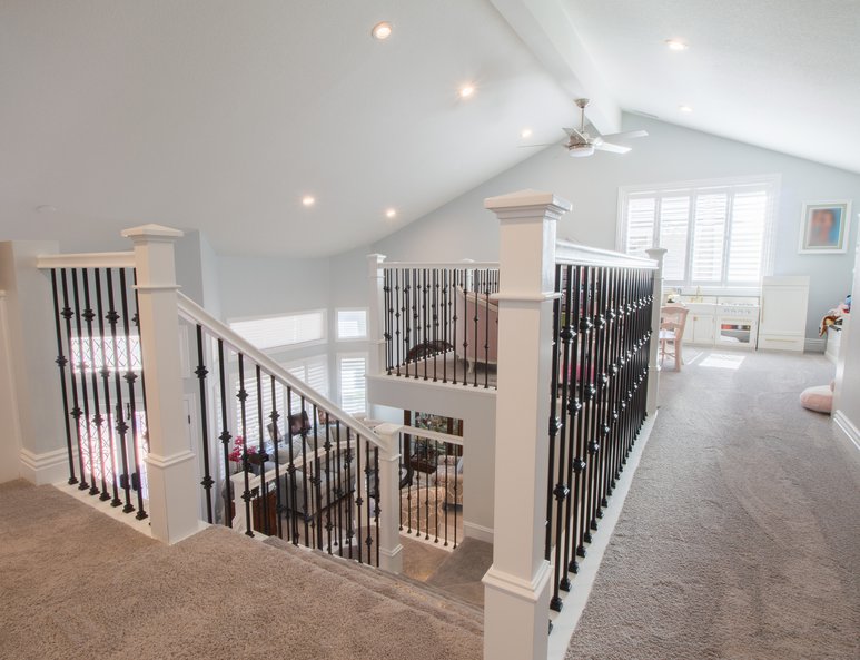 Beautifully reconfigured stairs leading to a newly added open loft playroom.