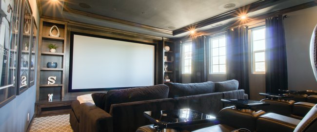 Home theatre with dark wood moulding and coffered ceiling