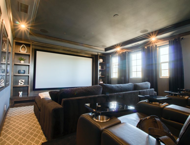 Home theatre with dark wood moulding and coffered ceiling