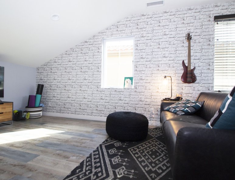 Family room and home office with faux brick wallpaper