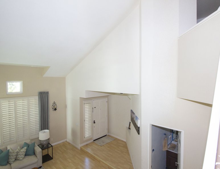 Home office created in high ceiling space above home's entrance