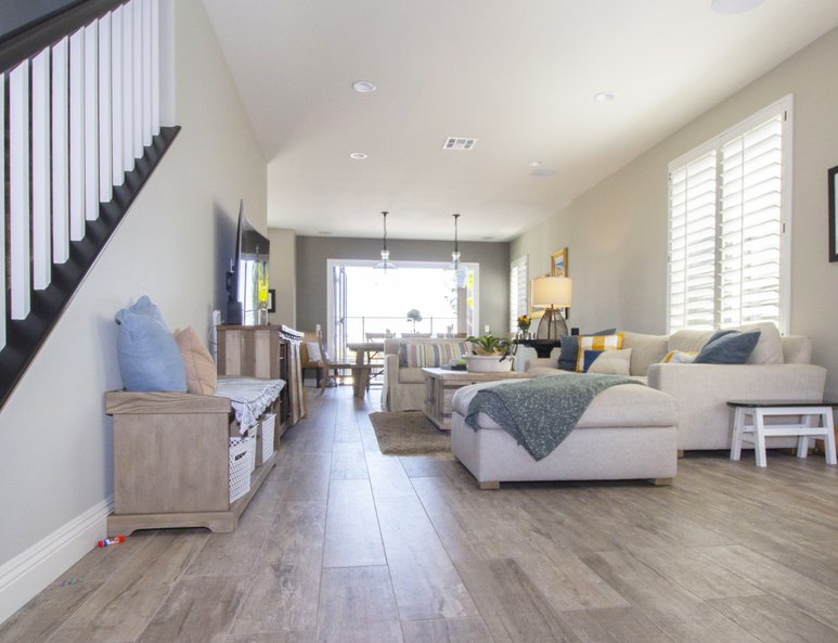 Living room with recessed lighting and open floor plan thanks to a wall removal and stair reconfiguration