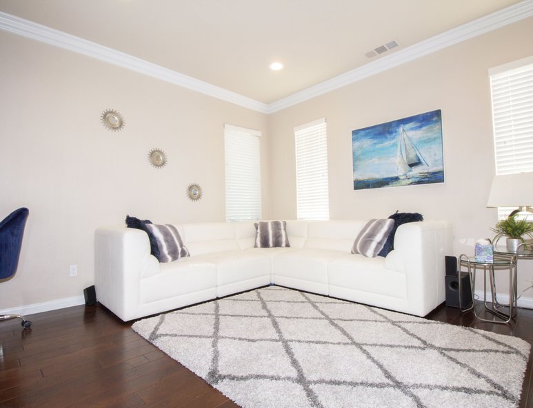 Guest bedroom with white wood closet doors and desk nook.