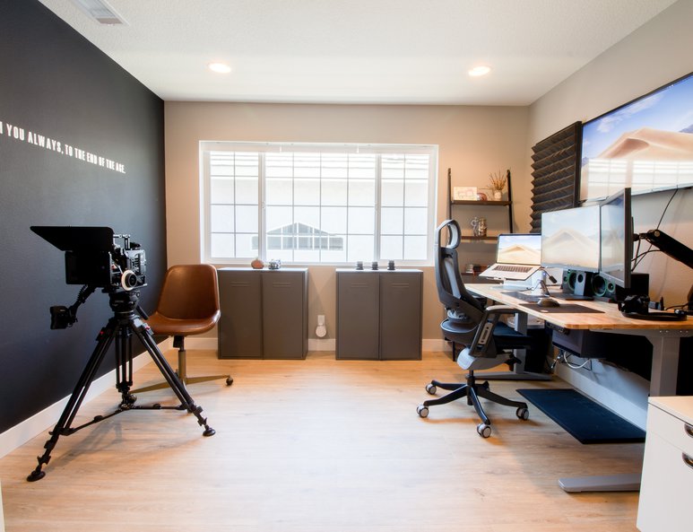 Home office with double pocket doors and ample lighting