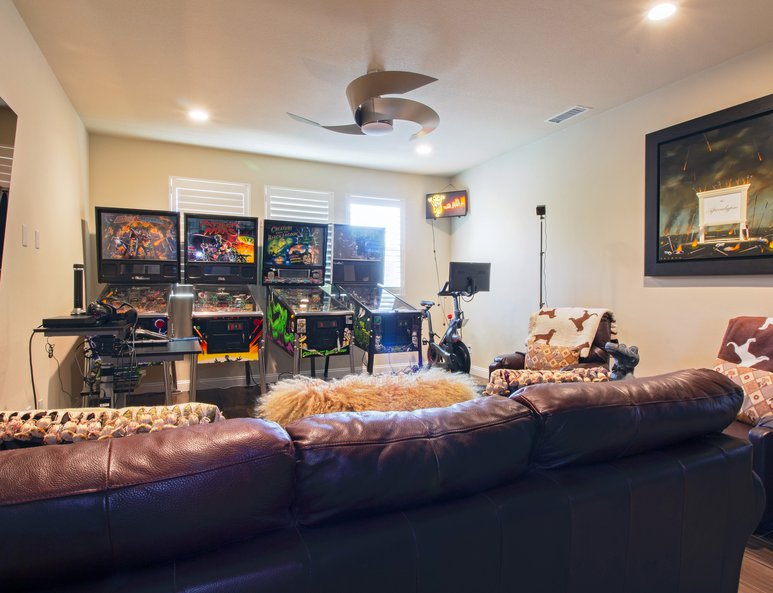 High ceiling space is filled in with a new game room with multiple pinball machines and plenty of space.