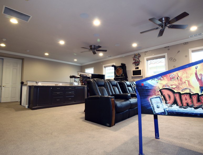 Cabinetry in game room with plenty of games and seating