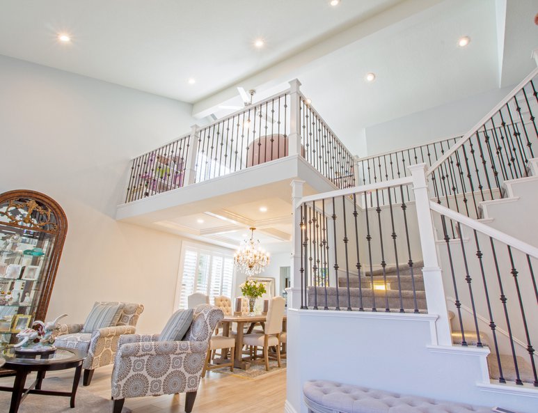 Dining room with coffered ceiling below newly added open loft playroom.