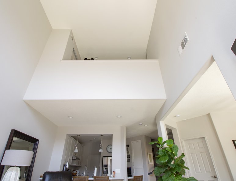 Upward view of newly installed open loft ponywall looking over downstairs living room